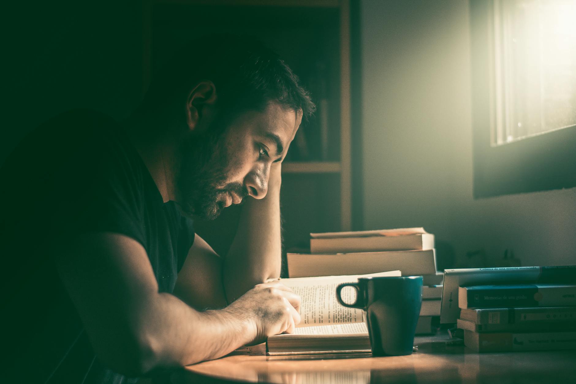 photo of man reading a book