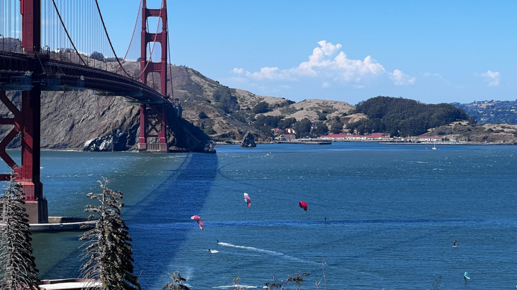 Kite surfers beneath the Golden Gate Bridge.