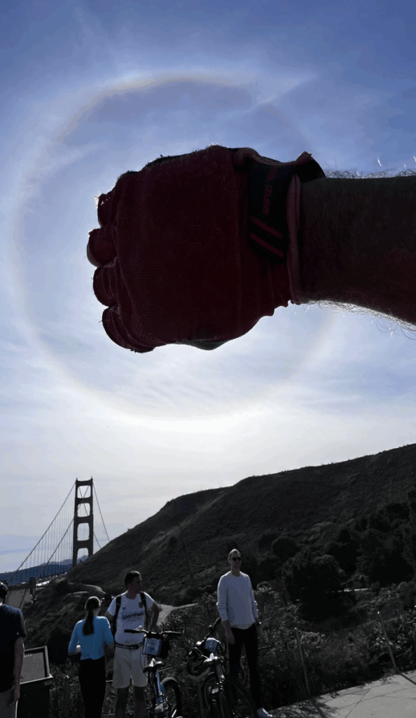 The Golden Gate Bridge with bicyclists nearby.