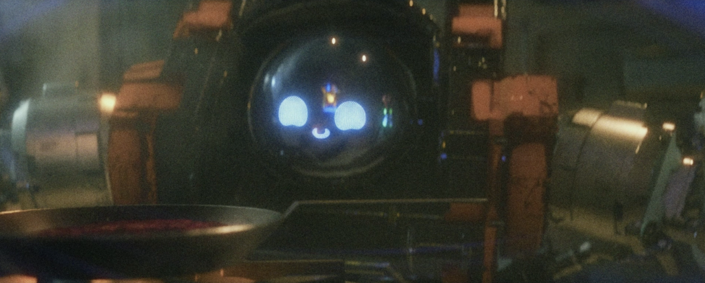 A robot looks at a frying pan.
