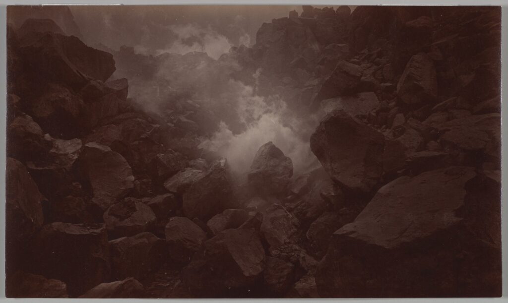 Large boulders atop a smoldering volcano.